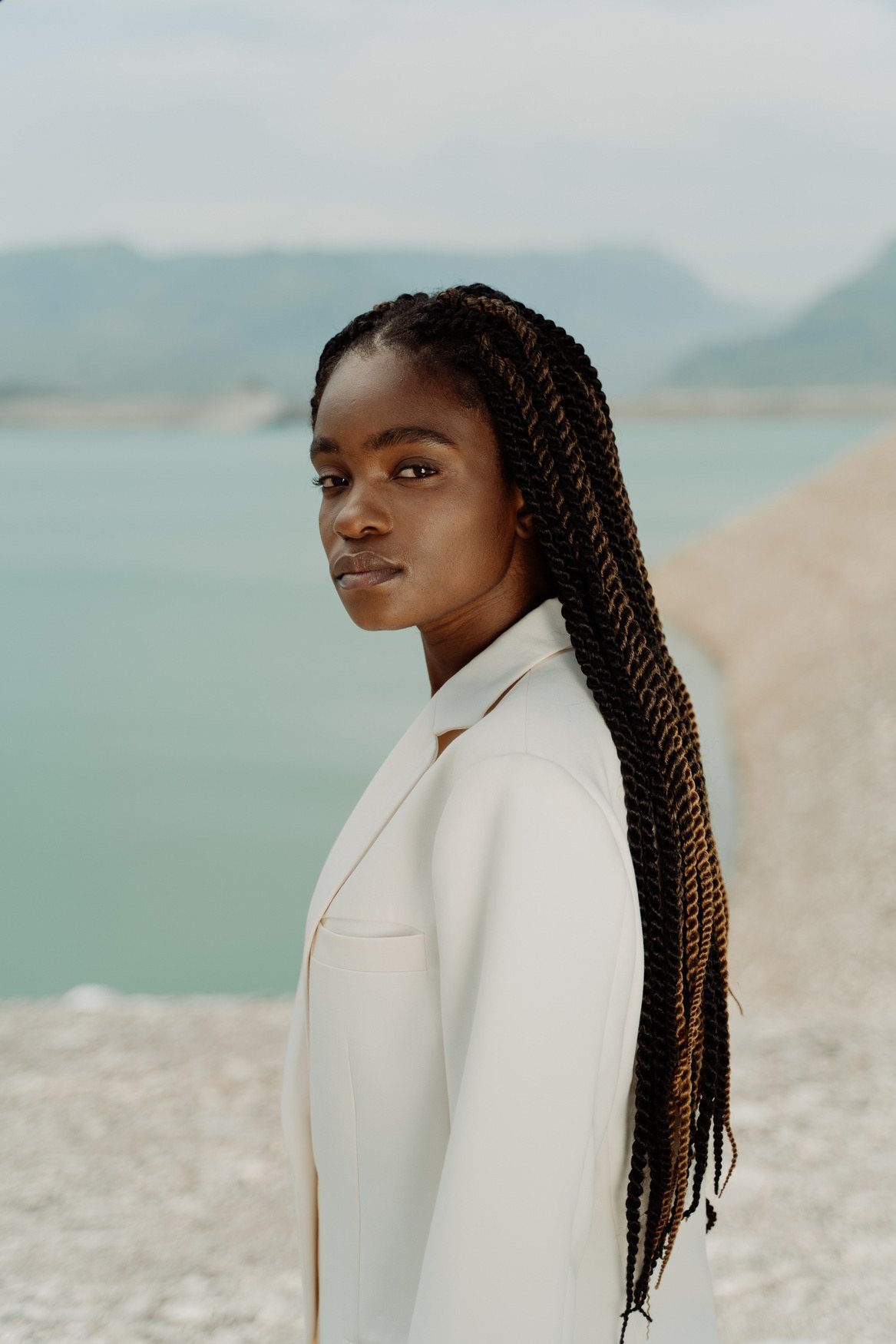 AUREA portrait — cream suiting at the shore