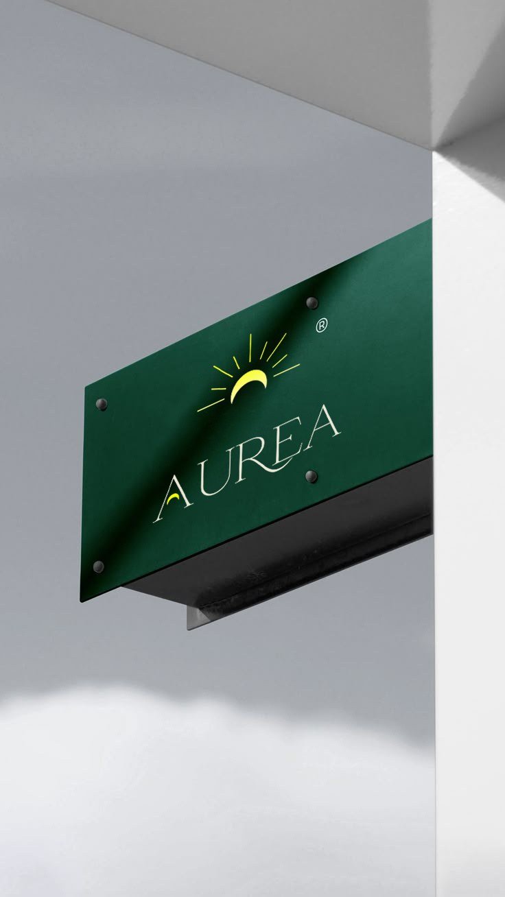 AUREA signage — gold mark on olive panel